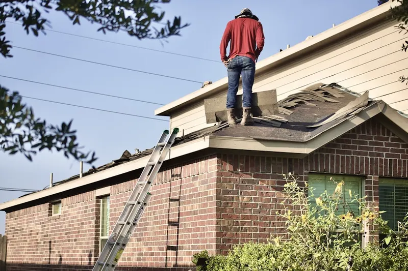 Professional roofer working on a residential roof in Villanova